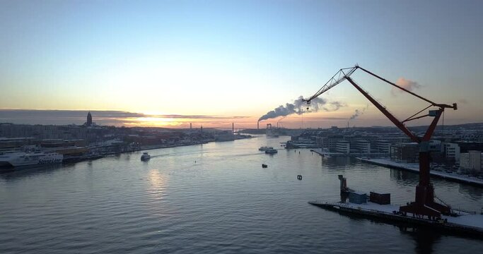 Boats Cruising At Gota Alv River At Dockland Area Of Lindholmen With Double Jib Cranes In Gothenburg, Sweden. - aerial