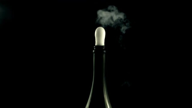 From the bottle rises up champagne with air bubbles. On a black background. Filmed is slow motion 1000 frames per second. High quality FullHD footage