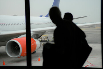 Passengers boarding an airplane at an airport