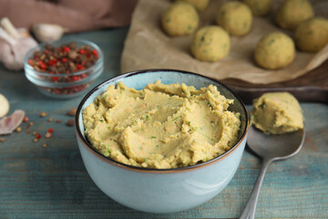 Bowl of chickpea puree on blue wooden table. Falafel recipe