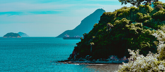 Rio de Janeiro, Brazil - CIRCA 2021: Coastal region of ocean beach during the day with sea, sand and rocks © @renatopmeireles
