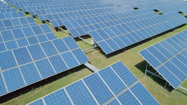 Aerial view of Solar Panels Farm solar cell. Renewable green alternative energy concept. Camera moves right. Close-up