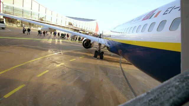 Frozen railing at the entry of a Ryanair plane ready for flight on the airport in cold winter