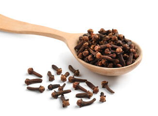 Aromatic dry cloves and wooden spoon on white background