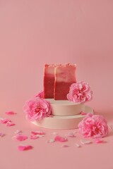 Rose soap. Beauty and aromatherapy. Flower soap. Pink soap bars and pink roses on podium on pink background. Rose Soap with Rose extract .Organic vegan eco cosmetics.