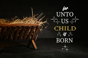 Manger with hay on dark background. Concept of Christmas story