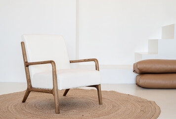 Minimal light and airy interior design, white and beige chair, rug and pillows