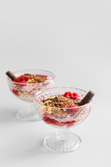 Tasty dessert with flax seeds and yoghurt in glass on light background