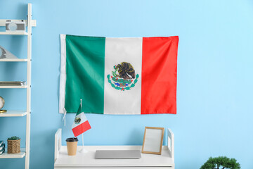 Stylish room interior with workplace and Mexican flag