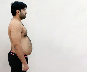Obraz premium Portrait of a asian fat man show out his body and big belly.