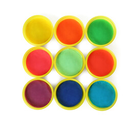 Plastic containers with colorful play dough on white background, top view