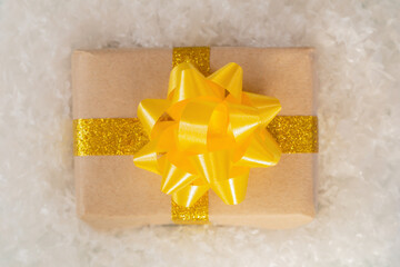 Gift box with a beautiful bow in the snow