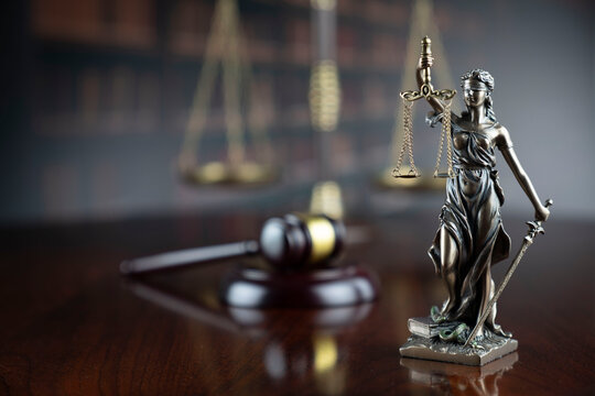 Law theme. Judge office - gavel of, scale and Themis sculpture.