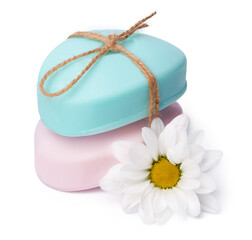 Bars of handmade natural soap and flowers on white background