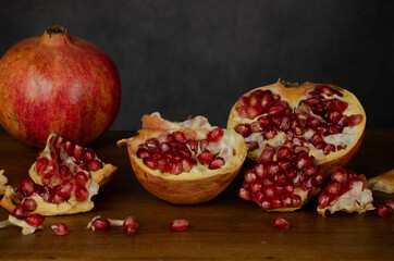 Still life of pomegranate fruits against gray wall