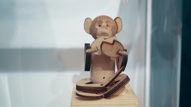A moving wooden toy of a monkey.