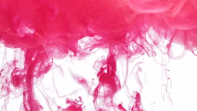 Flows of pink color paint rise to cloud in transparent liquid as decorative abstract background slow motion extreme closeup
