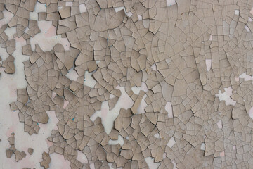 Peeling paint on the wall. Old concrete wall with cracked flaking paint. Weathered rough painted...