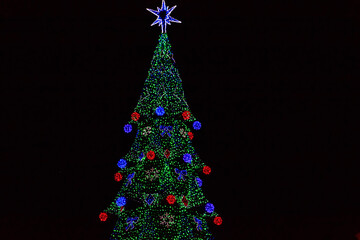 Decorated Christmas tree with multi-colored lights at night