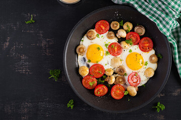 Fried egg, mushrooms and tomatoes. Keto, paleo breakfast. Top view