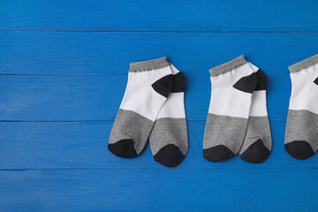 Cotton socks on blue wooden background