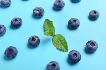 Ripe blueberry and mint on color background, closeup