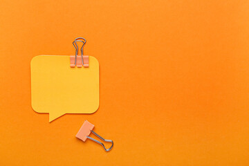 Sticky notes and binder clips on color background