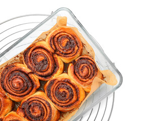 Baking dish of tasty cinnamon rolls on white background, closeup