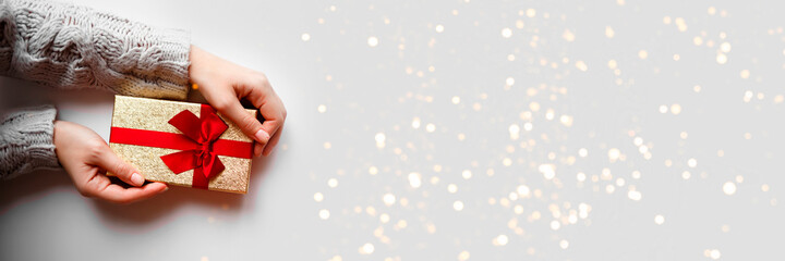 hands hold a gift on a white background