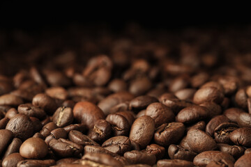 Heap of aromatic roasted coffee beans, closeup