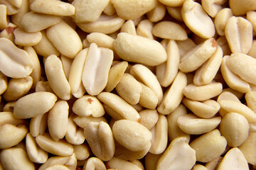 Raw blanched peanuts as food background