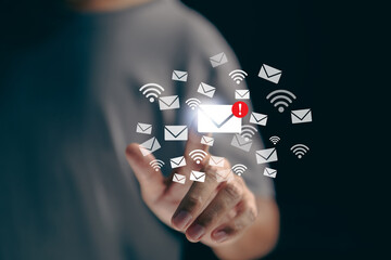 On a virtual touch screen, a businessman presses an email icon/ Email concept.
