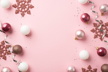 Top view photo of pink and white christmas tree balls pink snowflakes silver serpentine and sequins...