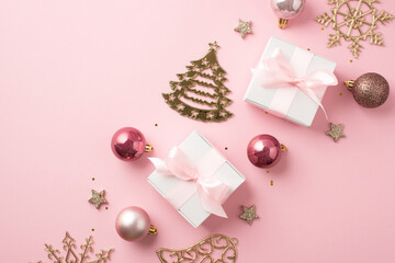 Top view photo of row composition christmas decorations pink balls gold bell pine snowflake shaped ornaments stars white gift boxes with pink bows and sequins on isolated pastel pink background