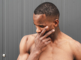 portriat of a muscular shirtless young fit african american man