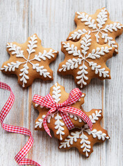 Christmas gingerbread cookies on white wooden background