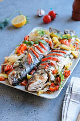 Grilled sea bass with tomato and onion.