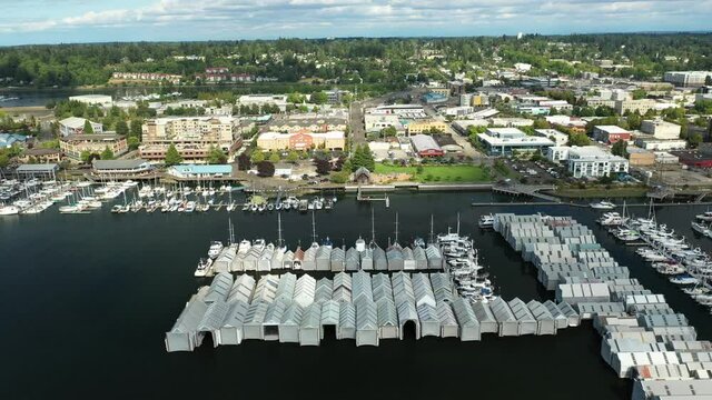 Cinematic 4K aerial drone trucking shot of the Olympia Yacht Club and West Bay, by Capitol Lake, with a panoramic view of Historic District in Olympia, Washington
