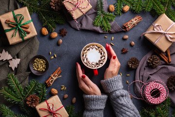 Christmas, female hands with gift boxes and cup of coffee