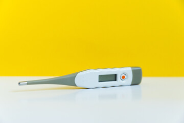 electronic thermometer without logo on a yellow background