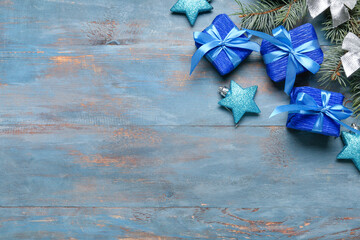 Christmas gifts and decor on blue wooden background