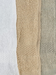 Fototapeta na wymiar three napkins towels of different colors of the same size on a white background