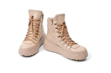 Womens beige leather boots with zip and lacing, photographed against a white background.