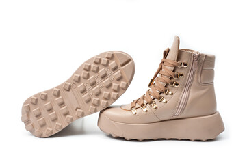 Womens beige leather boots with zip and lacing, photographed against a white background.