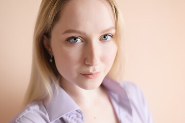 Fototapeta premium Portrait of a beautiful young woman with blue eyes.