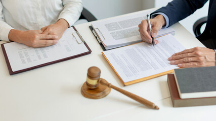 law concept The legal practitioner reading an official document that his advisee, the man in white...