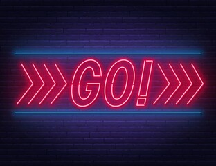 Go neon sign on brick wall background.