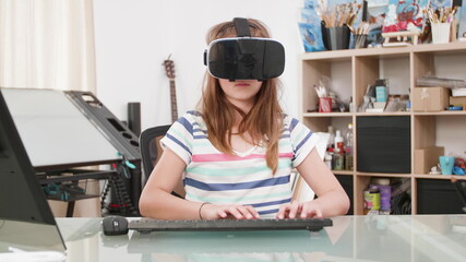Young child with virtual reality headset playing space shooter videogames during online game...