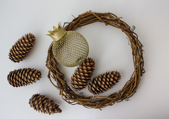 Large pine cones, a Christmas tree toy ball with a crown and a wreath of branches. New Year's decorations close-up isolated