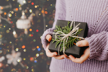 Female hands holding gift box. Christmas and New Year holidays concept.